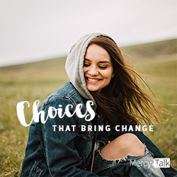 Choices that bring change, young lady in a hooded jean jacket in a beautiful green pasture. Beautiful smile.