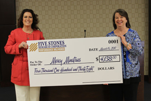 Mary Brainerd (right) accepting Five Stone’s donation from Joni Green (left) of behalf of Mercy.