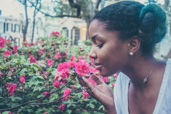 Girl smelling flowers, connecting with God in nature